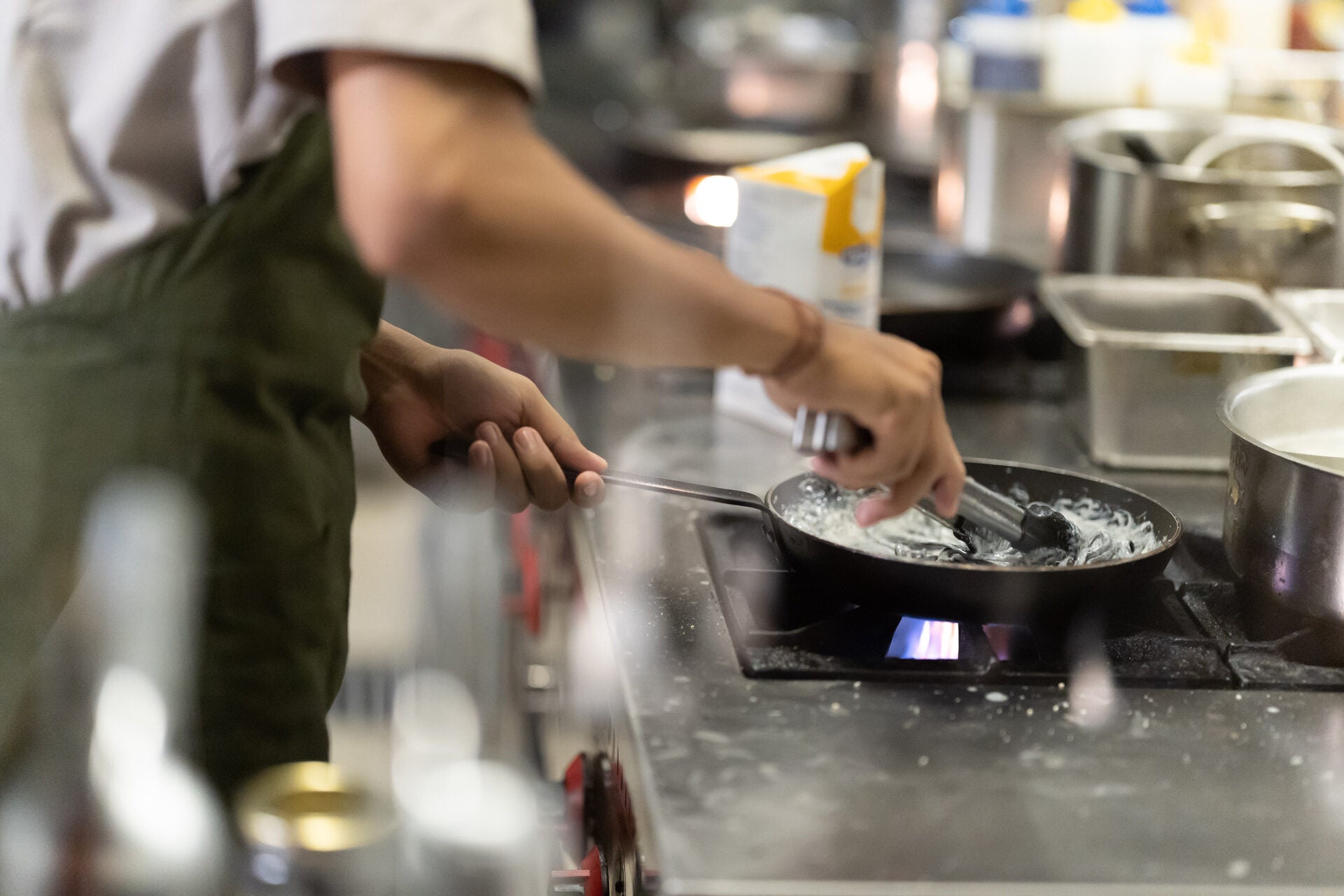 Chef cooking in a professional commercial kitchen at Le Gourmet Factory